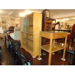 A retro bookcase with sliding doors and a side table