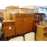 A retro five drawer chest and two bedsides