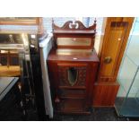 A Mahogany mirrored back music cabinet