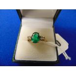 An 18ct yellow gold, Emerald and Diamond three stone ring,