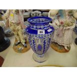 A large blue overlay glass vase