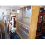 A retro bookcase with sliding doors and a side table