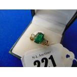 An 18ct yellow gold, Emerald and Diamond three stone ring,