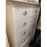 An eight drawer white chest