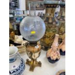 A Victorian hand painted oil lamp with Ormulu base,