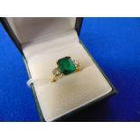 An 18ct Gold ring set with Emerald and Diamond centre stone,