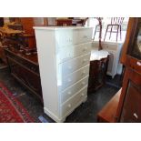 A white chest of eight drawers