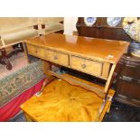 A sofa table with three drawers