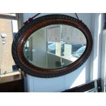 An oval Mahogany wall mirror