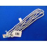 A set of three grey Pearl necklaces,