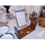 An adjustable wooden book rack and a brass photo frame