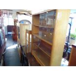 A retro bookcase with sliding doors and a side table