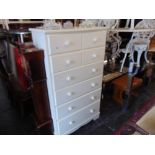 A white chest of eight drawers