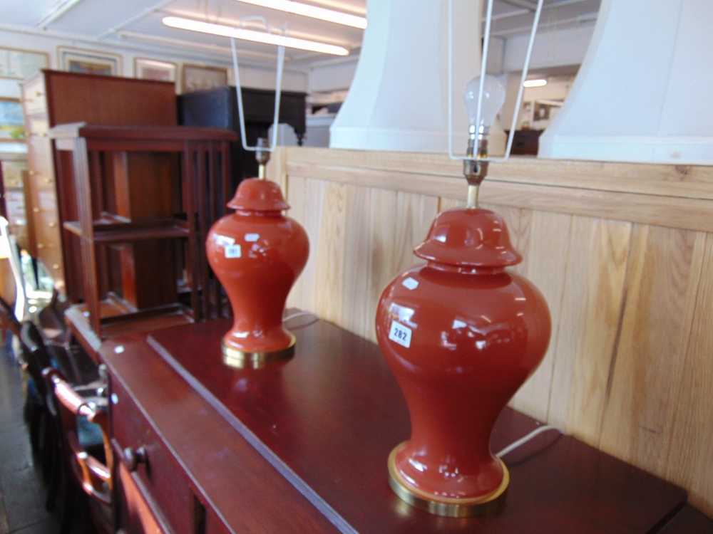 A pair of Red table lamps with shades