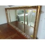 A gilt framed tryptic over mantle mirror
