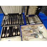 A boxed set of hallmarked silver spoons, tongs, boxed sets of cutlery etc.