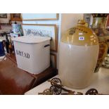 A bread bin and a large stoneware pot