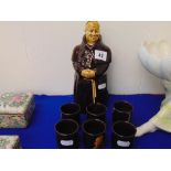 A ceramic Monk decanter plus six ceramic cups