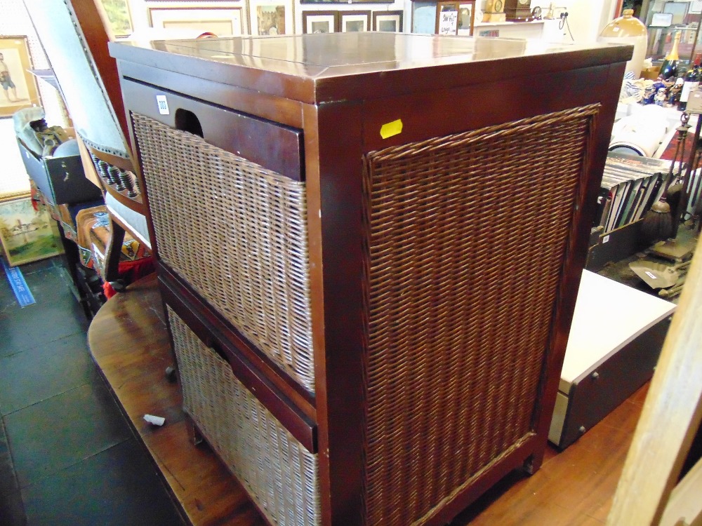 A Mahogany and rattan two drawer cabinet