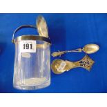 A lidded preserve jar and two Silver spoons,