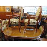 An Oval Mahogany dining table and five chairs,