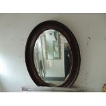 An Oval Mahogany wall mirror