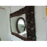 A heavily carved wall mirror