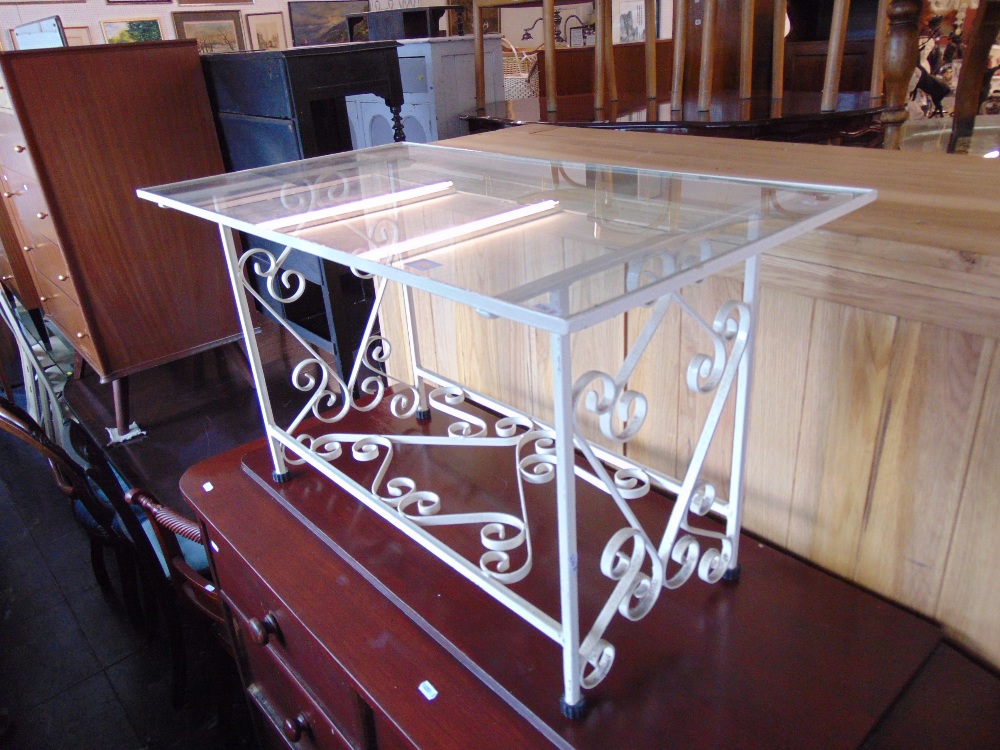 A wrought iron glass top table