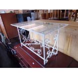 A wrought iron glass top table