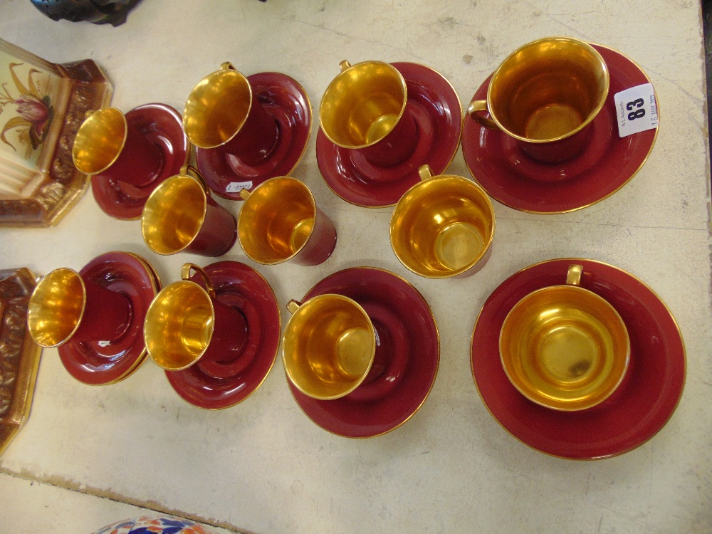 A Crown Devon red/gilt part coffee set, one cup chipped, 11 cups,