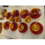 A Crown Devon red/gilt part coffee set, one cup chipped, 11 cups,