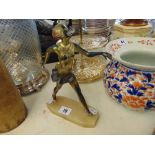 A brass figure of a flapper girl,