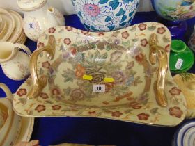 A decorative two handle dish