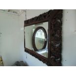 A heavily carved wall mirror