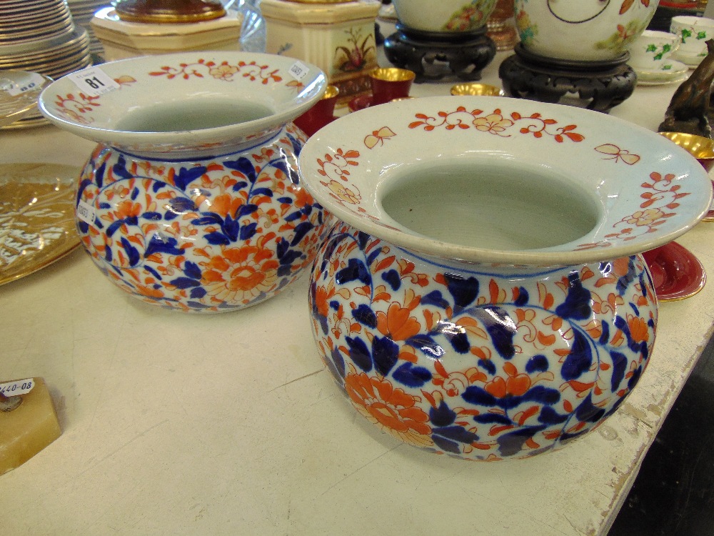 A pair of Oriental Red/ Blue and white vases, hand painted,