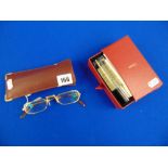 A pair of Cartier glasses with paperwork and accessories and a soft case