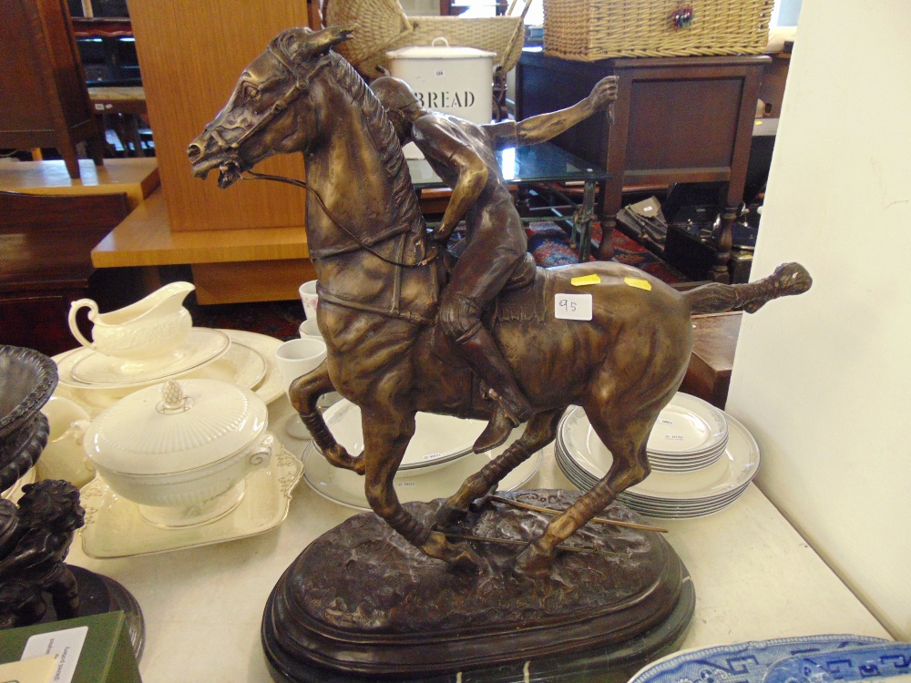 A bronze Polo player on base