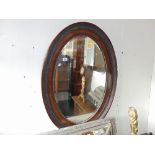 An Oval Mahogany wall mirror