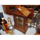 A wooden and brass mantle clock