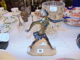 A brass figure of a flapper girl,
