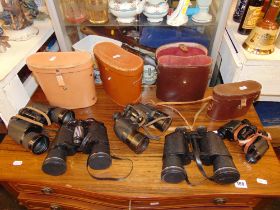 Five assorted binoculars