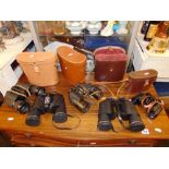 Five assorted binoculars