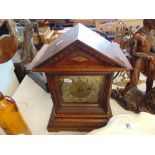 A wooden and brass mantle clock