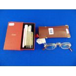 A pair of Cartier glasses with paperwork and assesories and a soft case