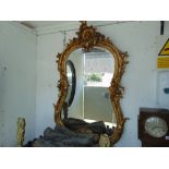 A gilt ornamental wall mirror