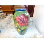 A Moorcroft vase, 1950's, was porters to Queen Mary, Hibiscus design, 32 cms H 18cm W,