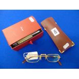 A pair of Cartier glasses with paperwork and accessories and a soft case
