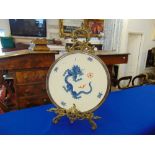 A Meissen plate with dragon design on a metal stand