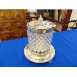 A cut glass silver plated biscuit barrel on stand