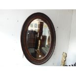 An Oval Mahogany wall mirror